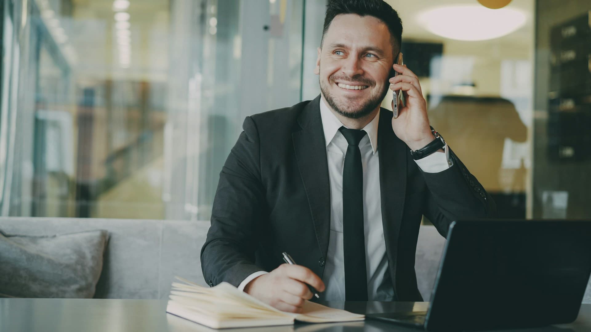 A salesperson celebrating a closed deal at their desk